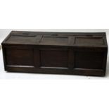 An oak blanket box, with a hinged triple panelled top and front, height 40.