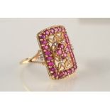 A yellow gold filigree style ring set with rubies and diamonds.