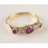 An 18ct gold ring set two diamonds and three rubies. Condition report: Size L.