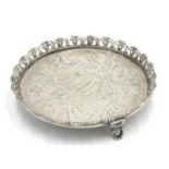 A continental silver card tray with ornate pierced rim and foliate engraved decoration,