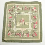 A Hermes "Cavaliers Arabes" silk scarf in green and pink, 83 x 85cm.