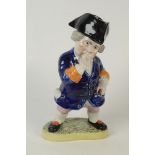 A Staffordshire jar in the form of Toby Taking Snuff, his tricorn hat a lid, height 33 cm.