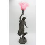 A French spelter figural lamp, late 19th century, entitled 'L'Orage' with cranberry shade,