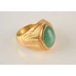 A contemporary Chinese 22ct gold jade set ring, 15.6g.