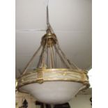 A brass hanging light fitting, with classical style panels and domed opaque shade, diameter 50cm.