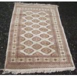 A Pakistan rug, the ivory ground with multiple rows of octagonal guls,