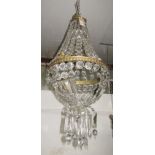 A gilt metal and glass chandelier, mid 20th century, of swept pear shape with domed base,