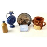 A Masonic impressed stoneware ink bottle, with blue rim together with other pottery.