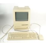 A Macintosh Classic II computer, keyboard and instruction manual.