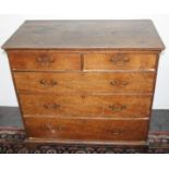 A George III oak chest of drawers, with two short and three long drawers on bracket feet,