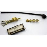 A church warden's pipe, a brass candle snuffer,