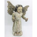 A carved wood figure of an angel, 20th century, with outstretched arms and painted finish,