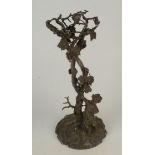 A Victorian silver plated table centrepiece stand, cast with a bacchanalian cherub on a rocky base,