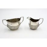 A half fluted silver sugar bowl and matching silver cream jug, 8.5oz.