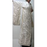 A Japanese full length cream wedding kimono embroidered with cranes and flowers,