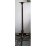A George III mahogany torchiere stand, the baluster stem on three cabriole legs with pad feet,