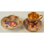 A Worcester post-war fruit painted cup with gilt interior and saucer,