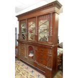 A large and impressive estate made cabinet with three lattice doors flanked by fluted columns,