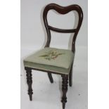 A Victorian mahogany child's chair, with a needlepoint seat and turned tapering legs.