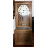 A light oak clocking in machine, circa 1960s, height 90cm, width 36cm.