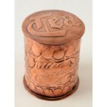 A Newlyn copper circular tea caddy, the body decorated with two fish, impressed Newlyn, height 10cm,