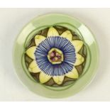 A Moorcroft pottery `Passion Flower` pattern coaster, shape 780, by Sally Tuffin,