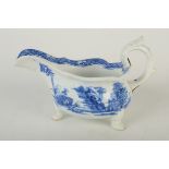 An early Bow porcelain sauce boat of silver shape, blue painted with the 'Two Pavilions' pattern,