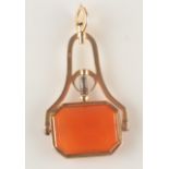 A gold folding watch key seal set with carnelian.