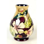 A Moorcroft pottery `Herb Garden Mallow` pattern vase, shape 32, by Philip Gibson, floral decorated,