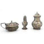 A fluted silver urn form pepper, one other silver pepper and a silver mustard, 3.