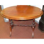 A Victorian mahogany centre table, the oval top on turned columns and downswept legs, height 75cm,
