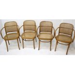 A set of four Dinette Polish bentwood armchairs, with a rattan back and seat, label to underside,