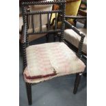 A Victorian ebonised bobbin turned armchair, height 82cm, width 54cm.