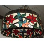 A large lampshade of Tiffany style, with opalescent panels of stylised foliage, diameter 51cm.