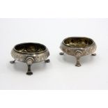A pair of Georgian floral engraved open silver salts on three clover feet by Dorothy Mills & Thomas