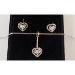 An 18ct white gold diamond pendant and matching earrings on fine snake link chain,