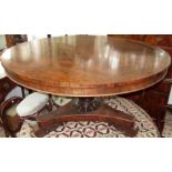 A Regency rosewood centre table, the circular top on a fluted stem,