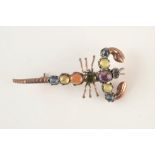 A gold and silver lobster brooch set with cabochon stones.