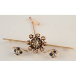 A 15ct gold bar brooch, at the centre a flowerhead diamond set and blue enamel cluster,