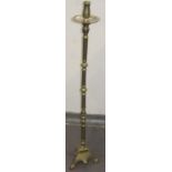 A brass altar candlestick, height 116cm. plus a painted wooden candlestick.