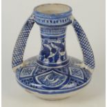 An Islamic blue and white twin pottery jar with squat body and trumpet neck, height 20cm.