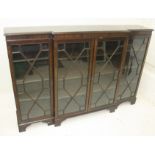 A mahogany breakfront bookcase, early 20th century, with four astragal glazed doors on bracket feet,