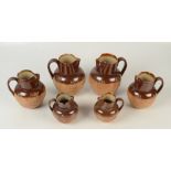 Six Doulton stoneware saltglazed jugs, damage.