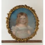A pastel of a young girl in a moulded gilt oval frame with a Victoria banner,