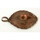 A Newlyn copper chamberstick, decorated with fish, impressed NEWLYN, length 26cm.