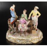 A Meissen revelling group, blue crossed swords mark to base, height 24cm, width 25cm, depth 20cm.