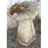 A granite mushroom on tapered base, height 69cm, diameter 45cm.