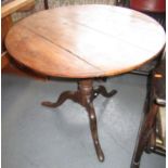 A George III elm tripod table,