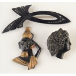 A carved jet silhouette brooch and two other pieces.