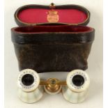 A pair of opera glasses, inscribed 'R & J Beck Ltd, 68 Cornhill, London', in a leather case.